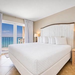 King bed in the master suite invites deep rest as your balcony frames endless blue skies and calm gulf waters