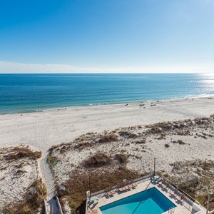 Enjoy breathtaking beachfront views from this inviting space, complete with a refreshing pool and sun loungers