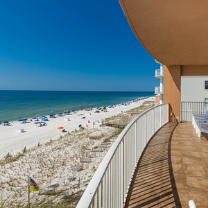 Breathe in the fresh air while relaxing on the spacious balcony with seating and views of the expansive coastline