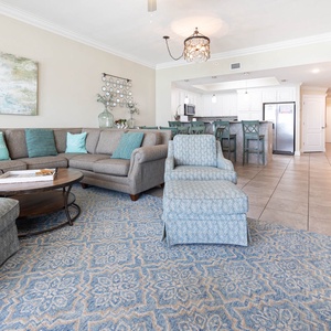 Relax in the spacious living area with a comfortable sectional, stylish decor, and easy access to the dining area