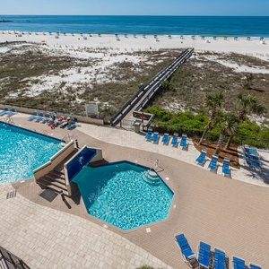 Dive into relaxation at the pool area, surrounded by lounge chairs and just steps from the beach access