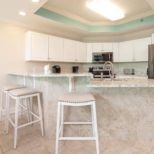 Enjoy casual meals at the breakfast bar, featuring stylish stools and a well-designed kitchen space for your culinary