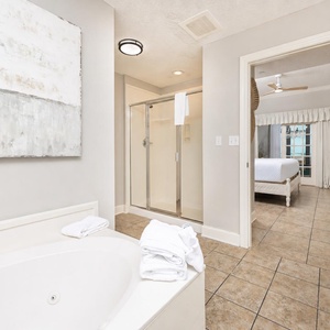 Refresh in the master bath after a day at the beach with a soothing jetted tub and relaxing walk-in shower