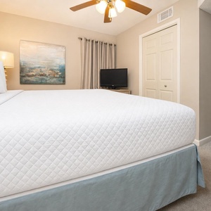 Retreat to the serene king suite, featuring a plush bed, soft lighting, and a cozy atmosphere for restful nights