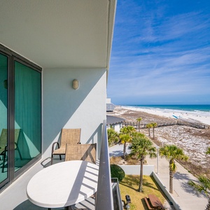 Quiet moments await on your balcony where you watch beachgoers stroll under a clear blue sky