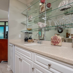 Enjoy refreshing drinks from the wet bar while soaking in the inviting coastal views from the balcony