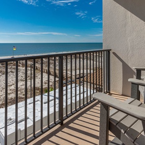 Enjoy stunning beachfront views from this balcony, featuring comfortable seating and a relaxing atmosphere