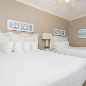 Rest in the soft queen beds, sharing stories under serene decor that invites relaxation after a day of beach fun