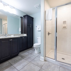 Refresh in this stylish guest bathroom featuring a spacious granite vanity, ample storage, and a walk-in shower