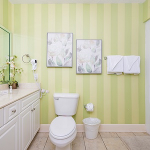 Refresh your spirit in this guest bath, where serene decor invites you to unwind after beach adventures