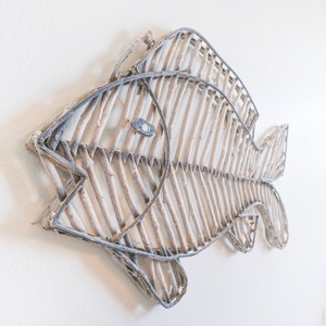 A decorative fish sculpture adds a coastal touch to the living space, enhancing the relaxed vacation atmosphere