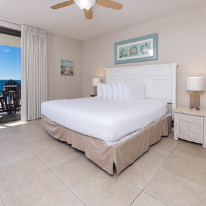 Relax in this inviting master bedroom with a comfortable king bed, vibrant decor, and beachfront balcony access