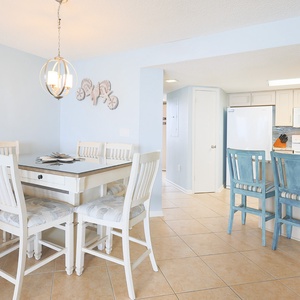Gather around the dining table or enjoy a quick bite at the breakfast bar in this welcoming dining area