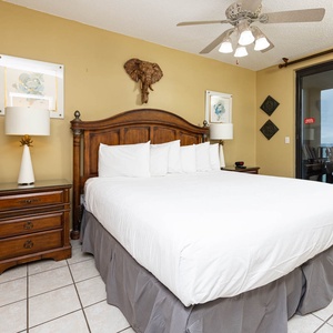 Unwind in the spacious master bedroom featuring a king bed, elegant decor, and beachfront balcony access