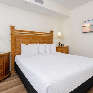 Relax in the guest suite with a queen bed and soft lighting casting a calming glow around the room