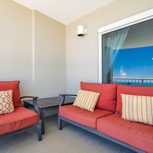 Relax in comfort on the private patio featuring cushioned seating and plush pillows perfect for unwinding outdoors