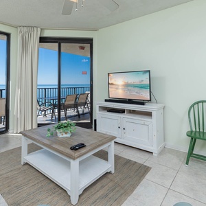 Relax in the inviting living area featuring a sofa with queen sleeper, TV, and stunning views through large windows