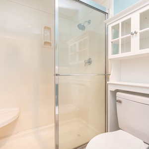 Refresh in the master bathroom featuring a walk-in shower, stylish cabinetry, and a clean, bright atmosphere