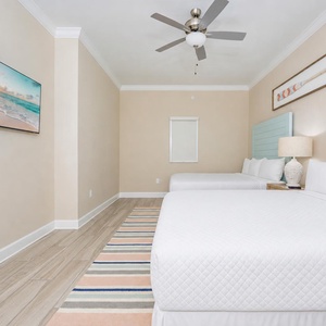 Charming queen guest suite with fluffy pillows and coastal decor