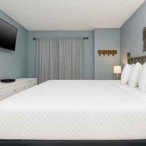 Relax after a day at the beach with your favorite shows in this soothing bedroom and drift into peaceful slumber