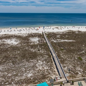 Stunning view of the beach and colorful umbrellas, leading to the boardwalk for easy access to the shore