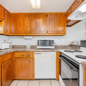 Kitchen featuring wooden cabinets, granite countertops, and modern appliances for a delightful cooking experience