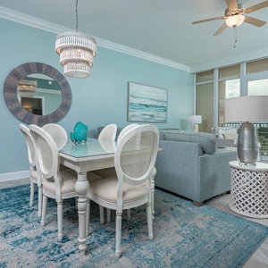 Relax at the elegant dining table, surrounded by coastal decor, while enjoying the tranquil beach views