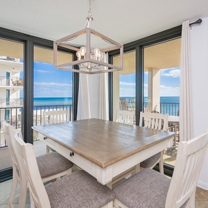 Dine at the wooden table while enjoying beautiful water views through large balcony windows