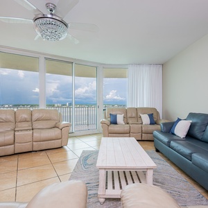 Living room featuring plush seating and panoramic views through expansive windows, perfect for relaxation