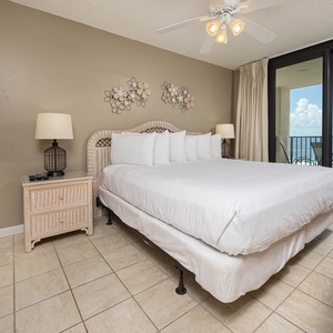 Inviting master bedroom featuring a king bed, stylish decor, and beachfront balcony access