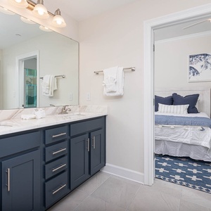 Refresh in this stylish guest bath with an elegant dual vanity before heading out for a beach day
