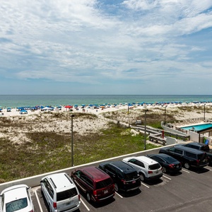 Enjoy refreshing beachfront views from this inviting balcony, perfect for relaxing and soaking in the vibrant atmosphere