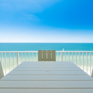 Savor meals at the outdoor dining table while enjoying expansive views of the tranquil waters and clear blue sky