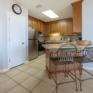 Granite breakfast bar with stylish seating, perfect for morning coffee or casual meals in this inviting kitchen