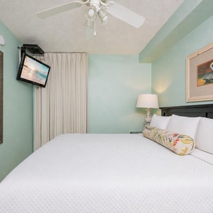 Fluffy pillows invite you to relax in the king suite for a calm movie night after a fun day at the beach