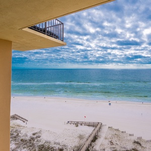 Enjoy breathtaking views from the balcony overlooking the serene beach, perfect for relaxation and unwinding