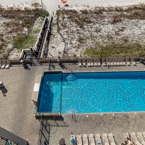 Take a refreshing dip in the inviting pool surrounded by lounge chairs and easy access to the beach