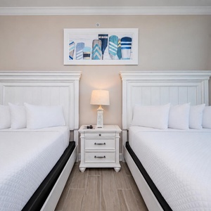 Inviting guest bedroom featuring two comfortable queen beds for restful nights in this cozy atmosphere