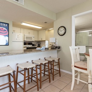 This kitchen features granite countertops, stainless appliances, and a cozy dining area, perfect for enjoying meals together