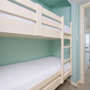 Bunk beds in the sleeping area offer a cozy spot for the kids after fun-filled days along the coast