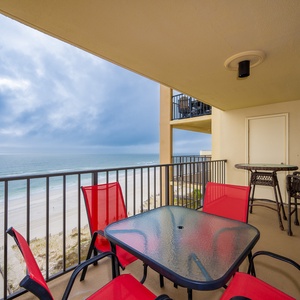 Enjoy the vibrant red seating on the balcony while taking in the breathtaking beach view