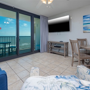 Relax in the inviting living area with a comfortable couch, dining table, and stunning views through large glass doors