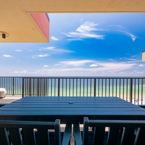 Enjoy breathtaking views from the balcony, featuring a stylish outdoor dining table and comfortable seating