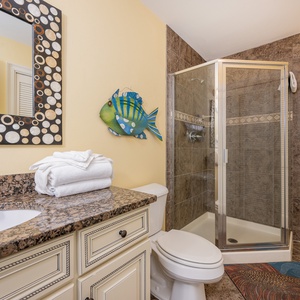 Additional bath featuring a walk-in shower, granite countertop, laundry area with washer/dryer, and playful fish décor