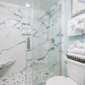 Soft sounds from the rainfall shower soothe you as you refresh in the master bath walk-in shower