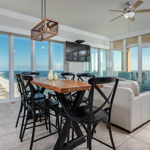 Gather around the rustic dining table with panoramic views, while enjoying the comfortable seating and modern decor