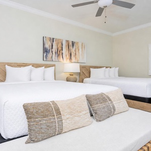 Experience restful nights in this guest room featuring two comfortable queen beds, soft pillows, and stylish decor