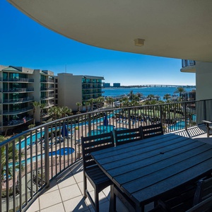 Enjoy refreshing breezes while lounging on the spacious balcony, taking in vibrant views of the bay and pool area