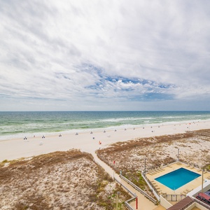 Enjoy stunning beachfront views and a relaxing atmosphere from this inviting space with a lovely pool nearby