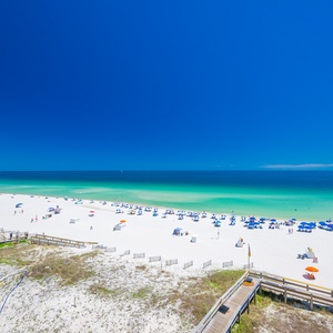 The sun warms your skin as you watch families play on the white sand and swim in clear turquoise water